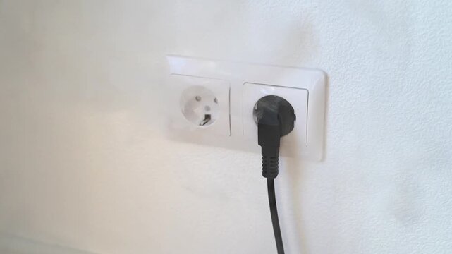 the outlet in the room starts to smoke from overheating of the electrical wiring. Overheating of electrical appliances. High quality FullHD footage
