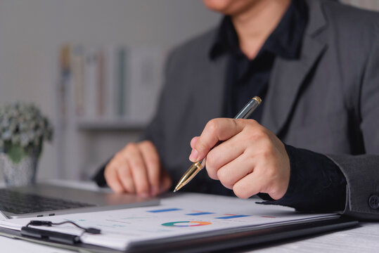 Manager evaluating business performance chart report clipboard typing laptop keyboard corporate strategic planning wealth management accounting audit.