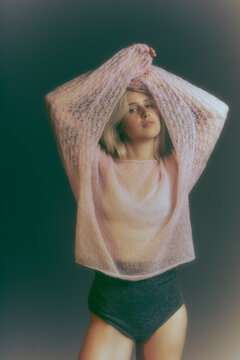 Woman wearing self-made crochet items. Handmade hobby.