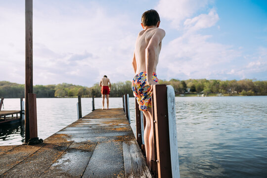 Kids preparing to jump from lakeside dock