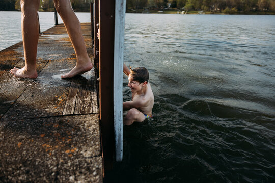 Boys swimming off dock at Lake Barkley in Kentucky