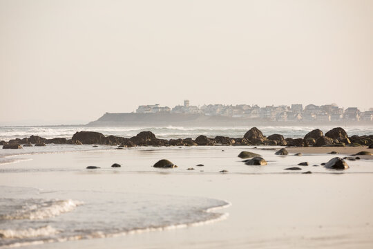 Houses in the distance with waves along the coast at Hampton Beach, NH