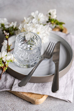 Spring floral themed table setting with cherry blossom
