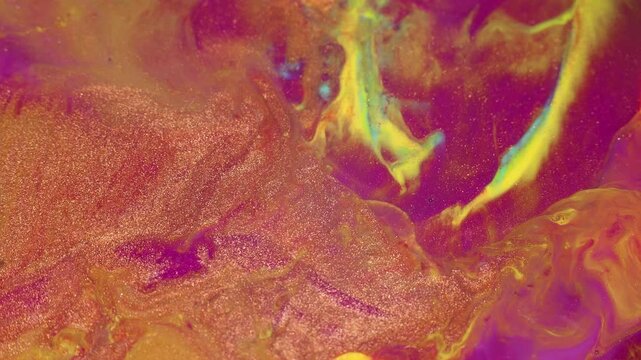 Macro shot of liquid acrylic paint texture with cells and color gold, yellow, pink mixing