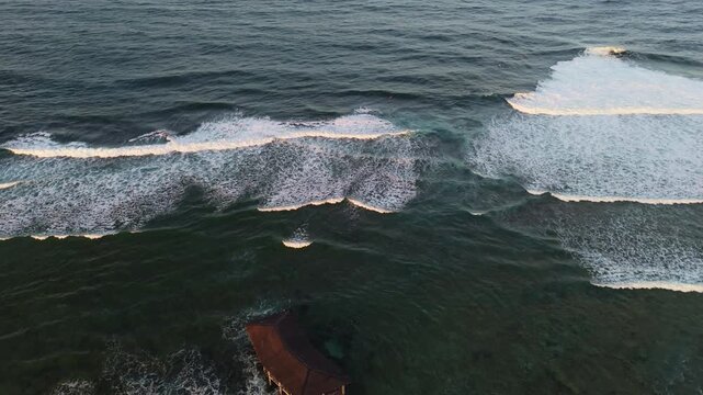 Aerial drone view of powerful Pacific waves breaking at the famous Cloud 9 surf break in General Luna, Siargao. Cinematic seascape of the iconic surfing destination in the Philippines