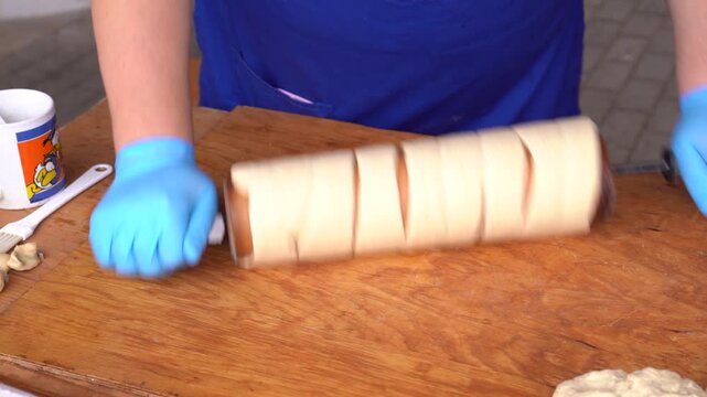 Preparing k&uuml;rt&ouml;s kal&aacute;cs dough for baking, a traditional Hungarian sweet street food