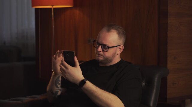 A man anxiously refreshes his phone, waiting for an important answer. The tension builds as he glances at the screen repeatedly, showcasing the impatience of modern communication.
