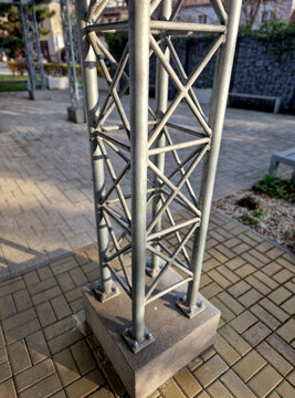 lattice tower or truss structure, Compression and Tension vertical post chors primarily handle downward weight compression diagonal cross-members bracing prevent  structure from buckling or shearing b