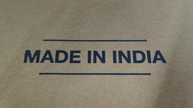 Made in india word or text printed on brown cardboard paper box. indian industry manufacturing label sign or symbol on product pack for export. Made in india stamp concept.
