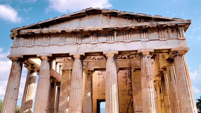 Temple of Hephaestus in the Ancient Agora of Athens, Greece. Well-preserved Doric order Greek temple made of Pentelic marble under blue sky. Classic antiquity and archaeological site.