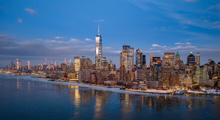 Obraz premium NYC night cityscape. NYC skyline night panorama. New York City skyline at night. NYC glowing city night.