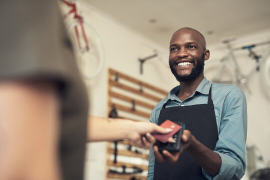 Man, customer and credit card in bicycle shop with POS machine, sale and payment for cycling gear. Happy, person and client in small business with fintech, cashless transaction and purchase of bike.