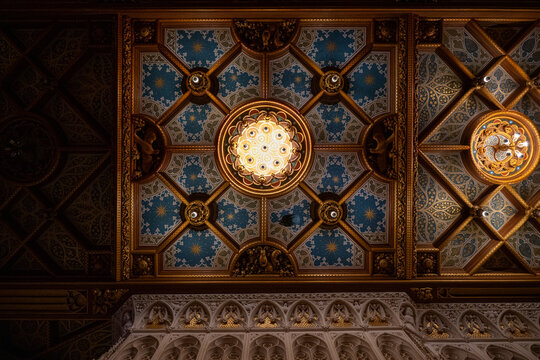 Gilded ceiling and chandelier light at Castle De Haar interior