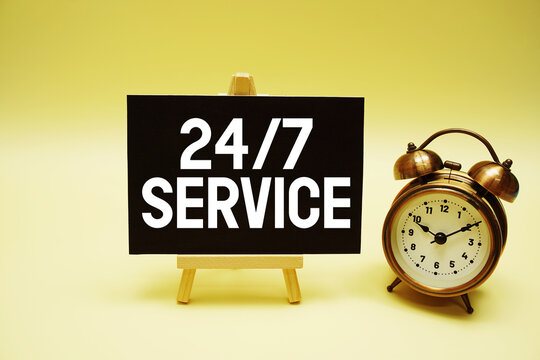 24 Hr 7 Day Service text message and alarm clock on yellow background