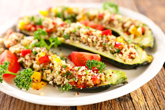 Baked Zucchini Stuffed with Quinoa Pepper and Tomato on White Plate
