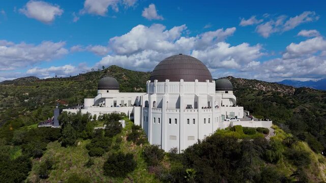 Griffith Observatory aerial drone orbit over hilltop landmark in Los Angeles California, February 20, 2026