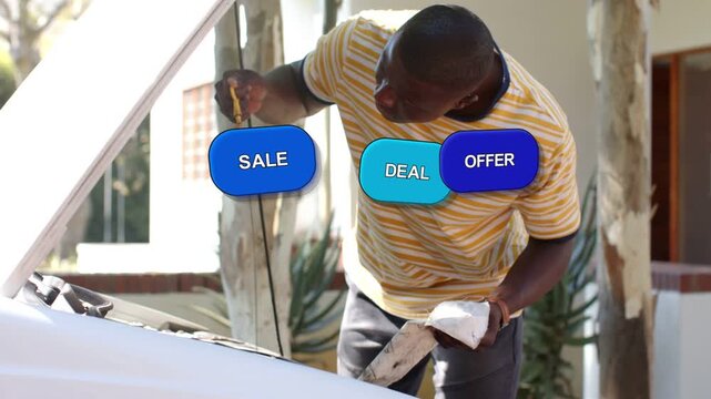 Man pulling dipstick wiping white rag inspecting engine as blue sale ads stacking, obscuring bay