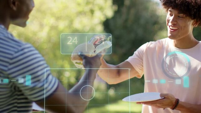 Two men bumping sandwiches in sunlit park, initiating tech showing 24 | 21 meters celebrating meal