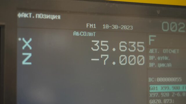 CNC machine control panel display showing machining parameters and absolute coordinates