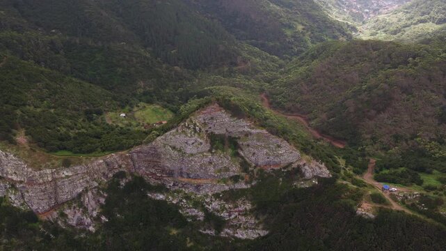 Aerial view of mountain valley in Madeira with forested slopes and roc