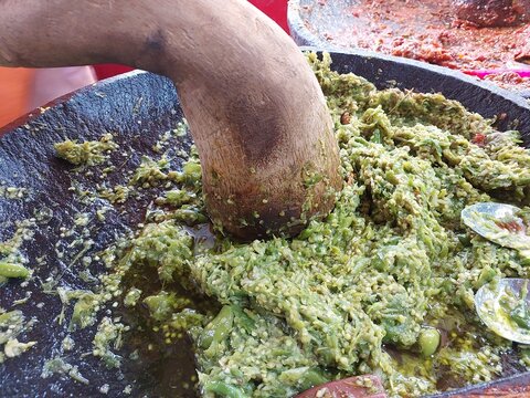 Green chilies are being ground to complement Sundanese food 