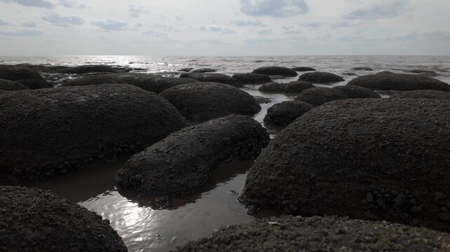 Hunstanton, Norfolk, England, UK.
Waves work their way around the rocks and create little rock pools where the water settles for a bit. The sun shines high through the mist, creates a calm atmosphere