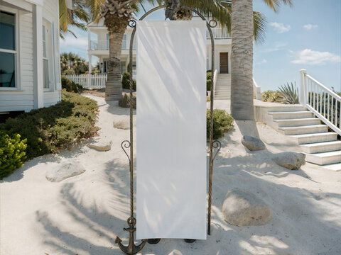 Nautical beach wedding mockup with blank white fabric banner on anchor stand. Coastal background with sand and palm trees. Outdoor textile welcome sign or event program template
