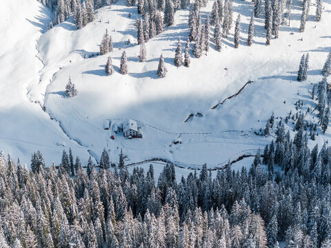 Winter landscape, aerial view of R&agrave; Stua refuge in snow covered forest, tourism concept. Sennes refuge,Sennes Braies Natural Park,Alto Adige,Veneto,Italy