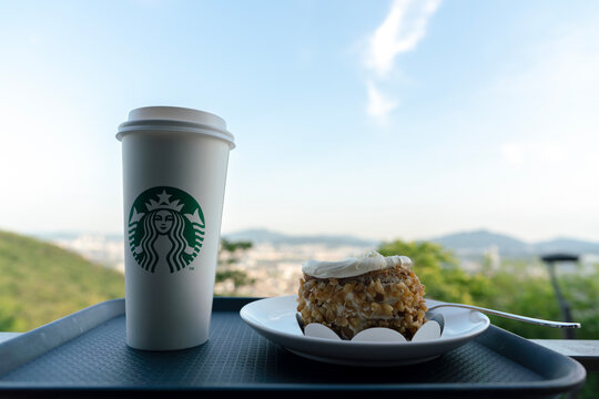 Starbucks coffee and carrot cake served on tray