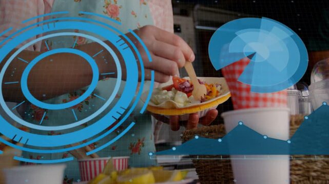 Woman making yellow plate food stall, reaching toppings, stirring as blue UI highlights for serving