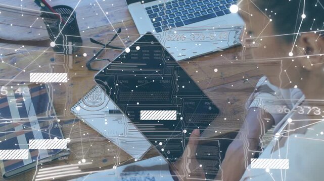 Woman reaching for tablet and tapping screen, overlay shifting over desk while checking laptop tech
