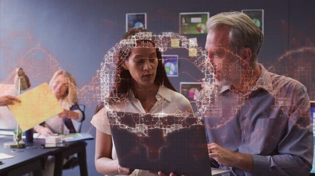 Man pointing laptop sparking holo net mapping tech data woman reviewing peer passing yellow folder