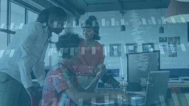 Woman tapping device causing charts overlay, seated man typing laptop, peer reviewing tech data