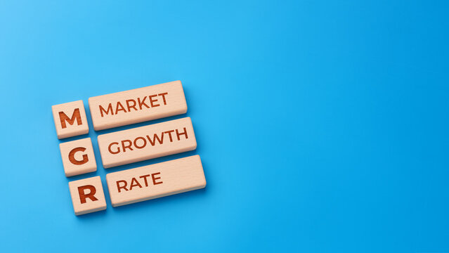 Market growth rate concept with wooden blocks and MGR abbreviation