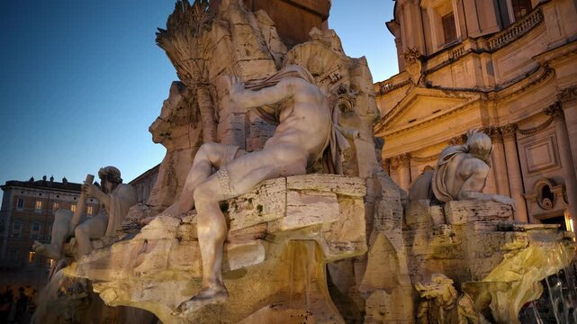 Fountain of Four Rivers sculpture at dusk in Rome with cinematic twilight lighting.
