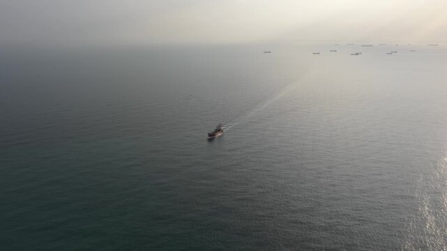 Aerial view of fishing trawler boat sailing in the open sea