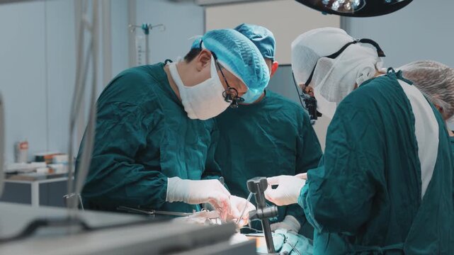 Group of surgeons performing a surgery procedure in a clinical operating room, carefully handling instruments and maintaining a steady workflow in sterile setup of a modern hospital environment. Steri