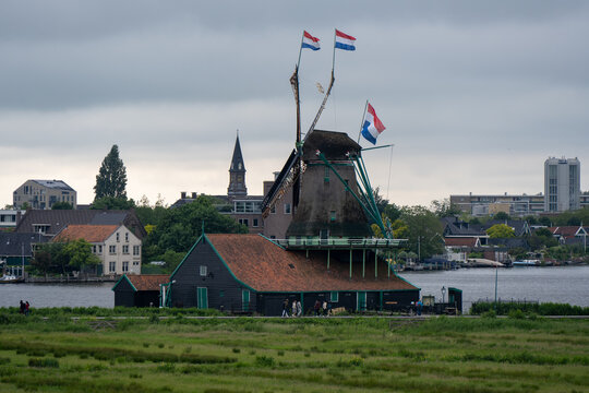 Historic windmill with Dutch flags at Zaanse Schans