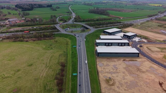 aerial view of junction 47 roundabout on the A1M motorway heading north through yorkshire with busy commuter traffic from cars and trucks