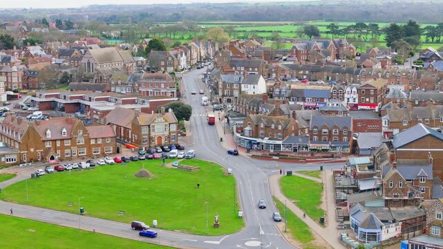 Aerial video of the British seaside town of Hunstanton in Norfolk showing the coastal area and beach and alsop the caravan holiday park. Chalk white cliffs with a lighthouse and sandy beach