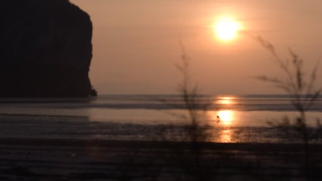 Hat Ratcha Mongkhon beach in Sikao District, Trang, Thailand. Tropical coastline with scenic rock formations, Golden Sun Sunset Beach