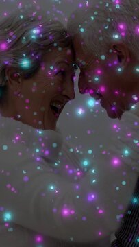 Senior couple laughing, leaning heads close showing love in health, purple-teal sparkles overlaying