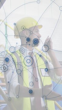 Vertical video: Construction supervisor raising radio talking and growing animated net for site ops