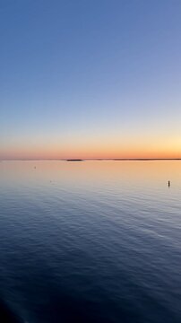 Vertical footage: Sunset over Gulf of Finland Spring Baltic Sea in Helsinki 4K