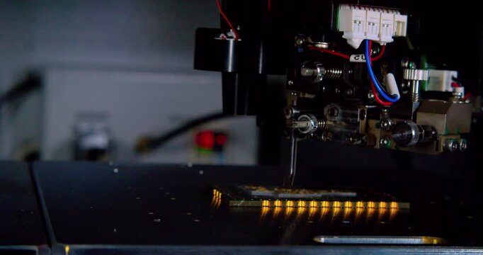 Modern industrial equipment. Industrial robot assembles an electronic board. Technological process of assembling a complex technical product .Close-up.