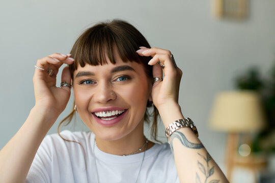 Bright smile of a young woman in a stylish apartment showcasing modern lifestyle