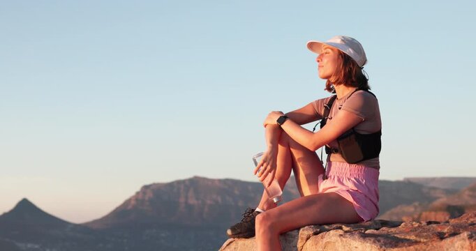 Woman, hiking and thinking with break on mountain top with view, space and relax on summit. Girl, outdoor and rest on peak for perspective, inspiration or trekking adventure with smile in summer