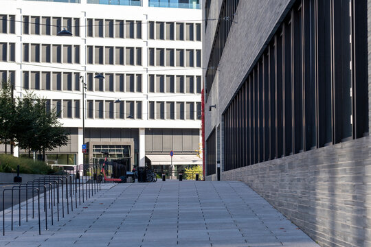 Modern minimal architecture buildings seen from plaza perspective in empty urban Oslo Norway creating quiet public space with strong geometry and daylight