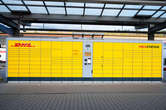 DHL post parcel boxes terminal at railway station in Trier, Germany, storing or deposit parcels for receiver, postal self service
