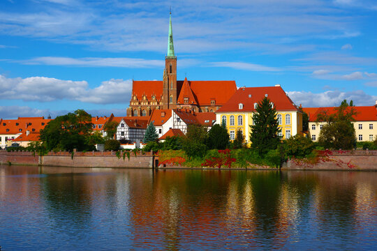 Wroclaw Cathedral and Ostrow Tumski view from across the Odra River with reflections in water